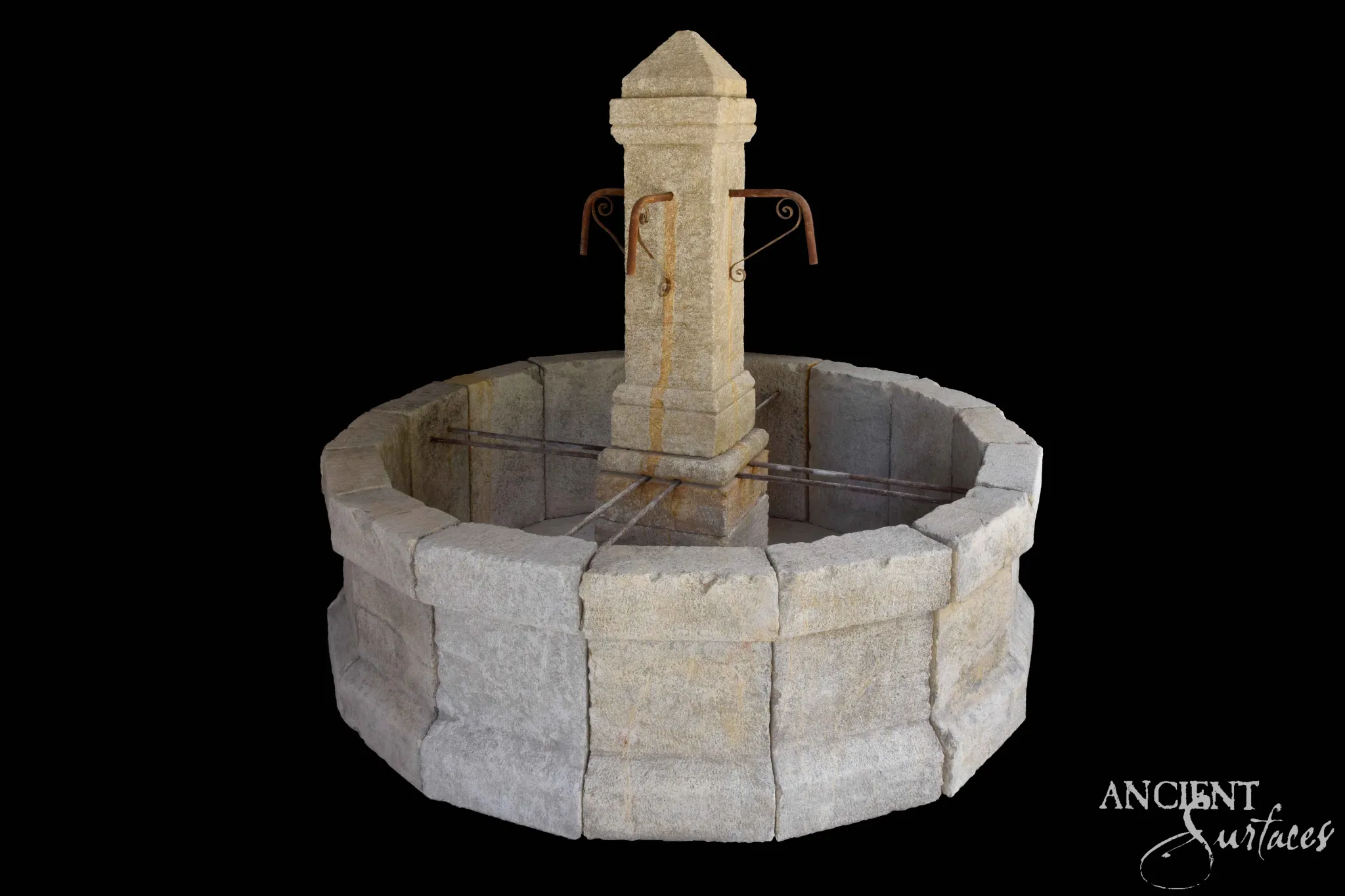 Reclaimed limestone pool fountain with a pyramid-capped column and iron scroll spouts